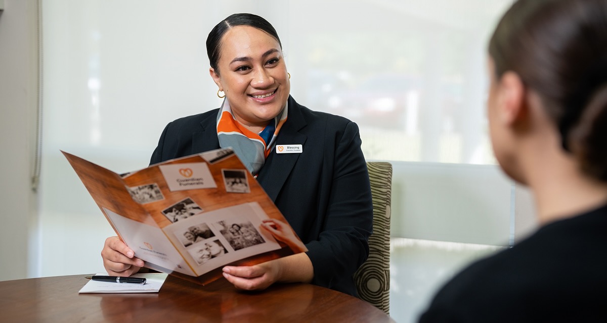 funeral director reading through a guardian funeral brochure