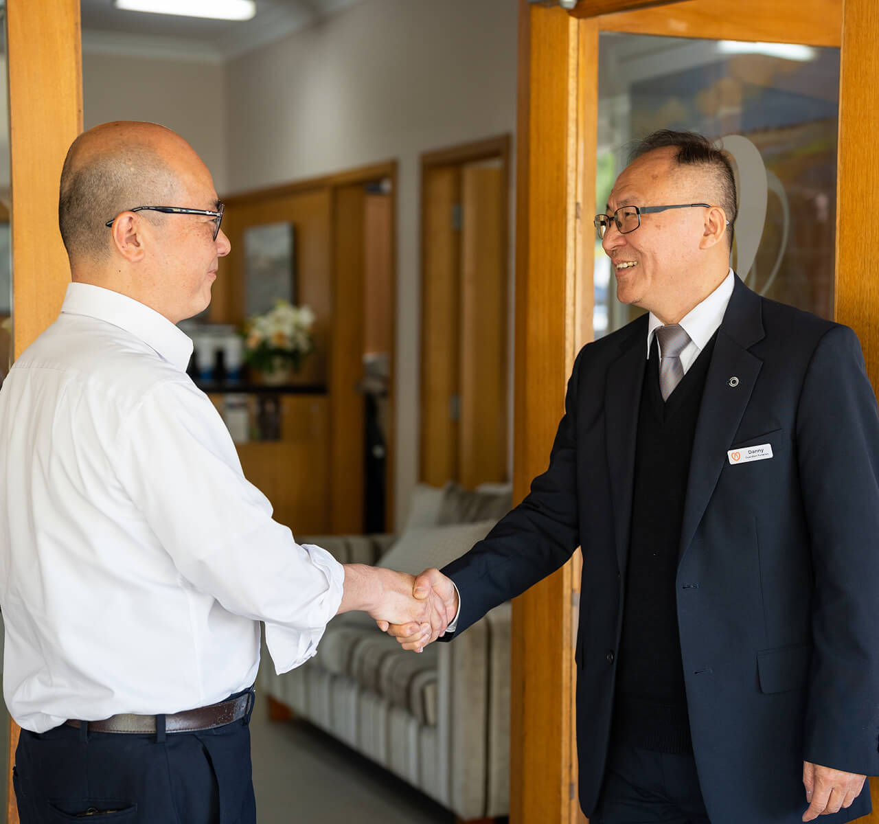 funeral director shaking hands with local man