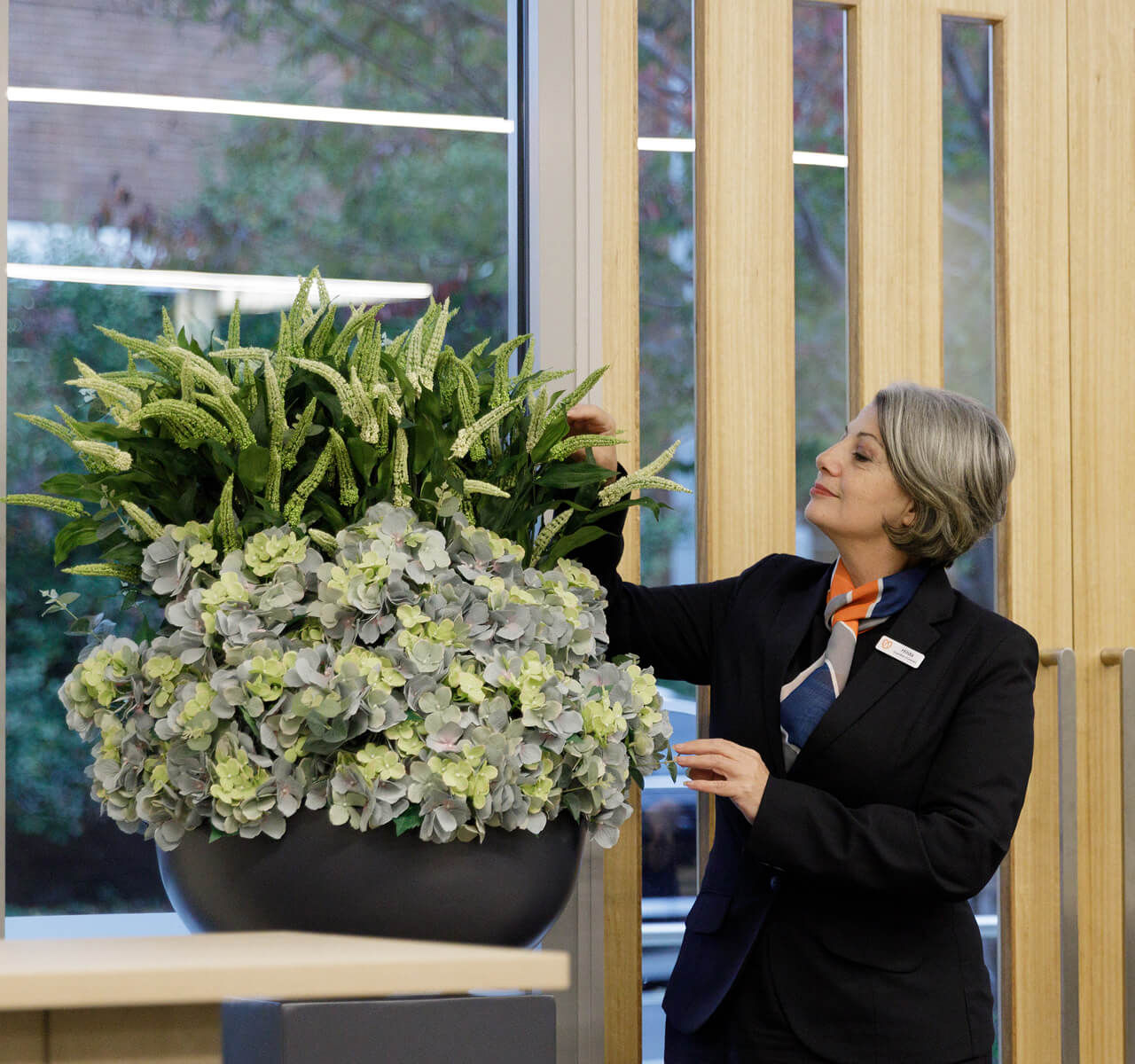 funeral director arranging flowers