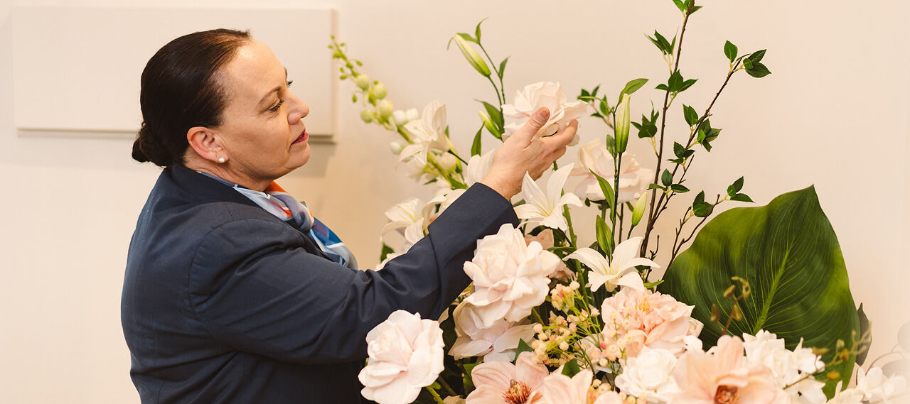 funeral director arranging flowers