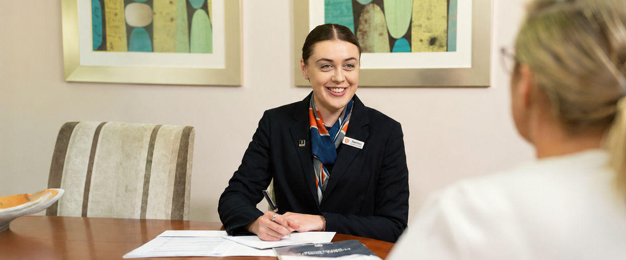 funeral arranger helping woman pre-plan a funeral
