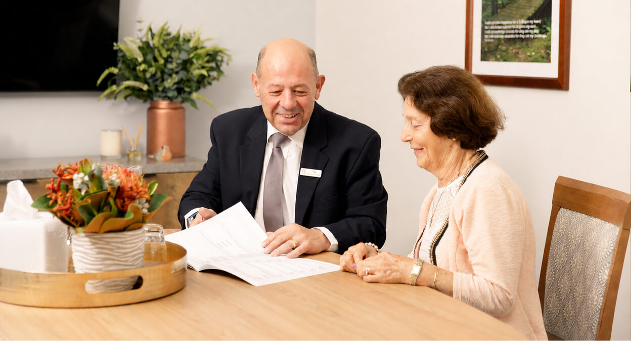 funeral director helping woman